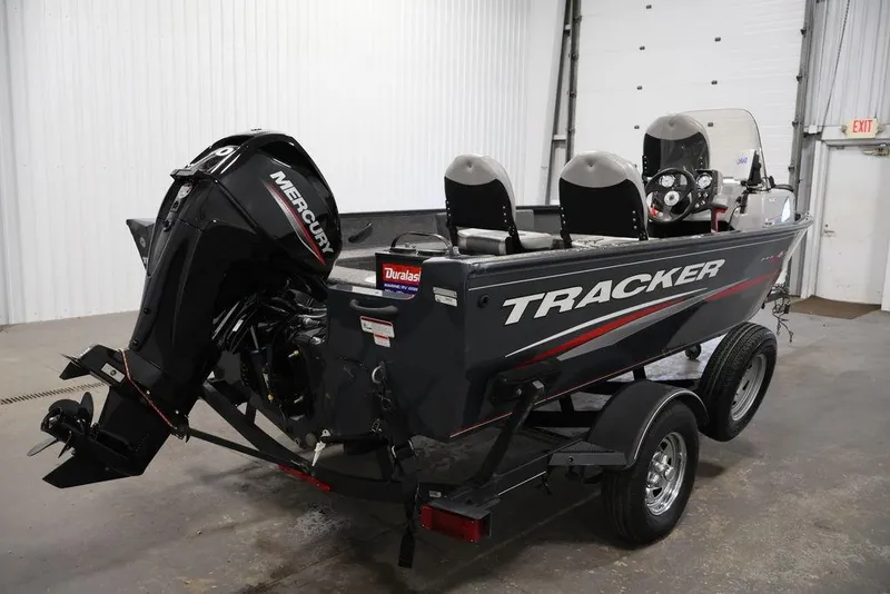 Slide: The Image of 2019 Tracker Pro Guide V-16 SC boat with Mercury engine in a garage setting. - 8