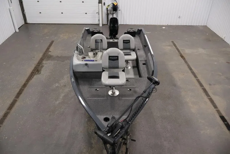 Slide: The Image of 2019 Tracker Pro Guide V-16 SC fishing boat in a garage setting. - 9