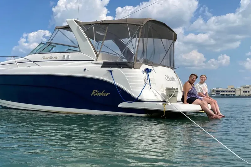 Slide: The Image of 2005 Rinker Fiesta Vee 300 boat with two people sitting on the deck, enjoying the water. - 6