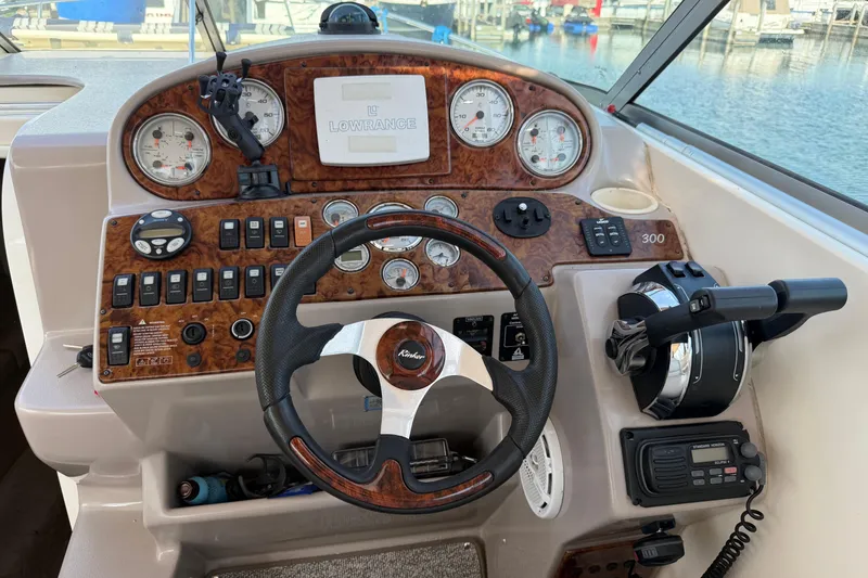 Slide: The Image of 2005 Rinker Fiesta Vee 300 helm with steering wheel, gauges, and controls. - 9