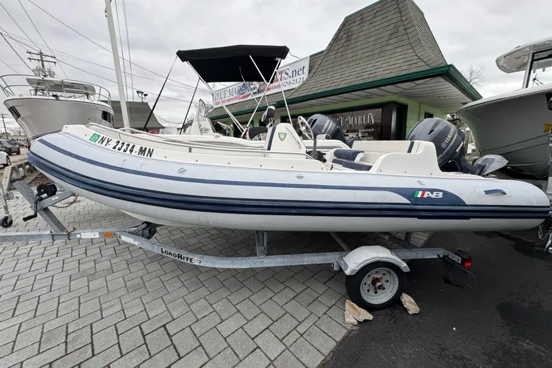 The Image of 2019 AB Inflatables Nautilus 15 DLX boat on trailer, parked outdoors. - 1