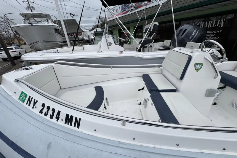 Slide: The Image of 2019 AB Inflatables Nautilus 15 DLX boat with seating, docked near other vessels. - 19