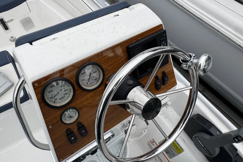 Slide: The Image of 2019 AB Inflatables Nautilus 15 DLX boat dashboard with steering wheel and gauges. - 6