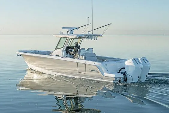 Slide: The Image of Manufacturer Provided Image: 2026 Boston Whaler 330 Outrage cruising on calm waters. - 1