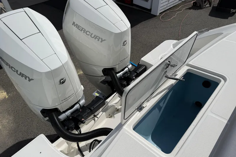 Slide: The Image of 2026 Boston Whaler 330 Outrage with dual Mercury engines and open storage compartment. - 10