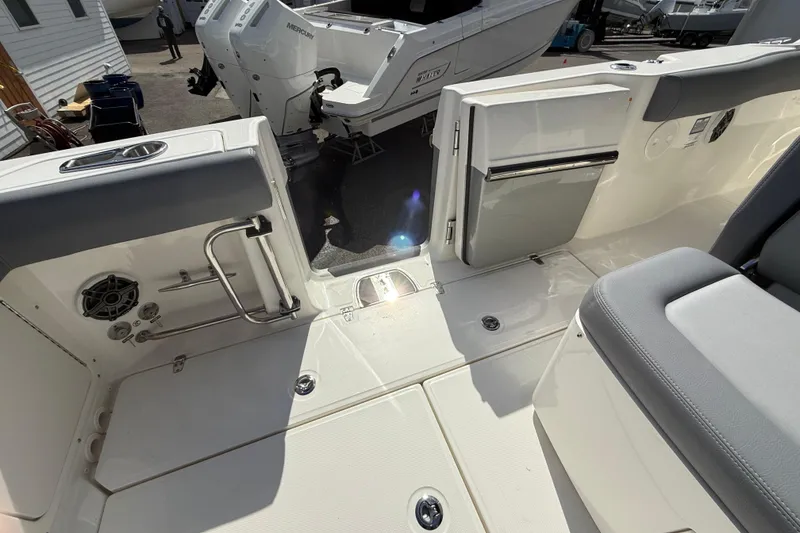 Slide: The Image of 2026 Boston Whaler 330 Outrage boat interior with seating and storage compartments. - 16