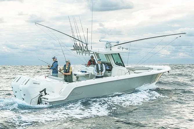 Slide: The Image of Manufacturer Provided Image: 2026 Boston Whaler 330 Outrage boat with anglers fishing on open sea. - 2