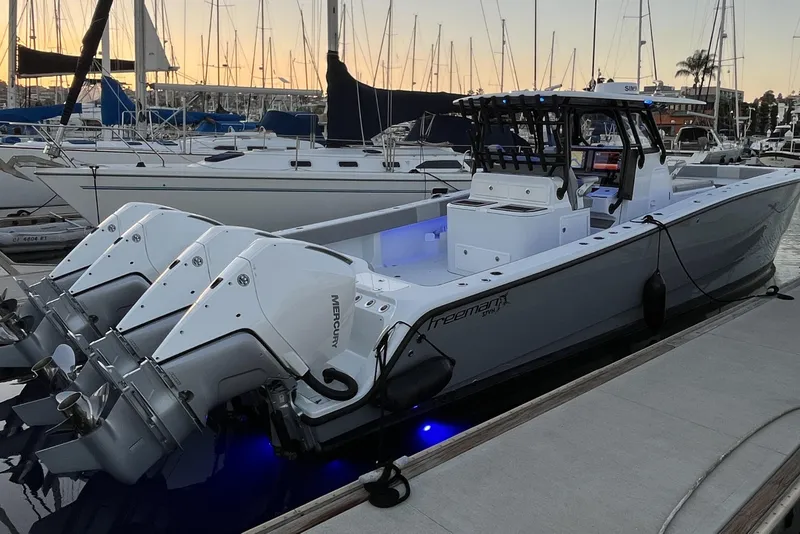 Slide: The Image of 2022 Freeman 37VH boat docked with triple Mercury engines at sunset. - 1