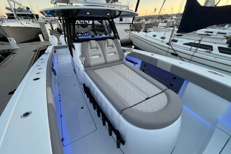 Slide: The Image of Luxury Freeman 37VH 2022 boat interior with cushioned seating and ambient lighting at marina. - 12