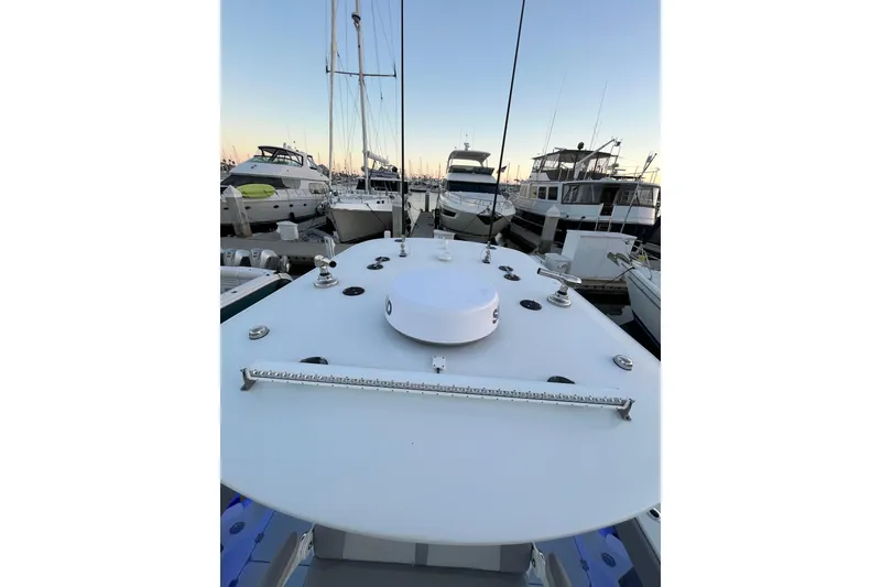 Slide: The Image of 2022 Freeman 37VH boat docked at marina, surrounded by other vessels at sunset. - 13