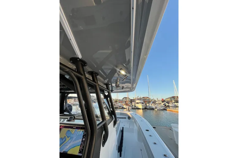 Slide: The Image of 2022 Freeman 37VH boat docked at marina, showcasing sleek design and navigation equipment. - 14