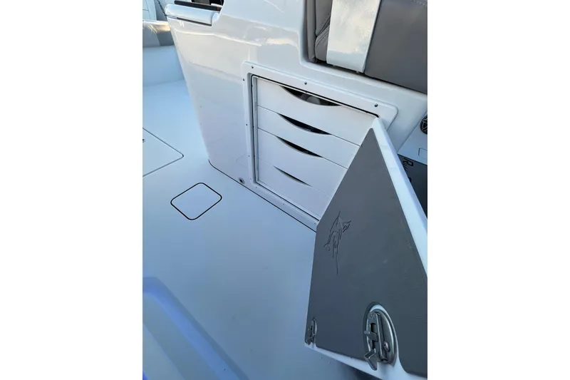 Slide: The Image of Freeman 37VH 2022 boat interior with open storage compartment and cushioned seating. - 19