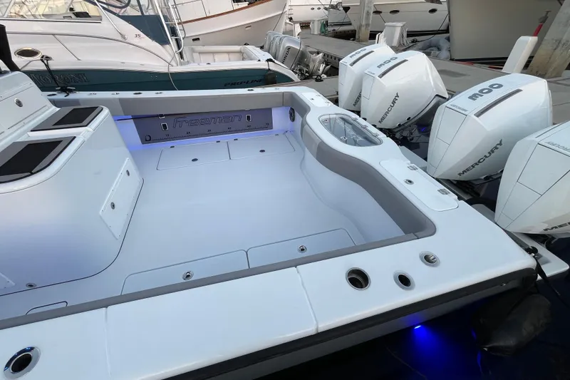 Slide: The Image of Freeman 37VH 2022 boat with Mercury engines docked, featuring spacious deck and modern design. - 2