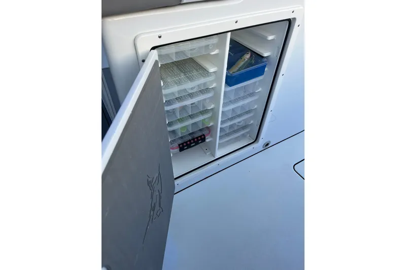 Slide: The Image of Freeman 37VH 2022 boat storage compartment with organized tackle boxes. - 20