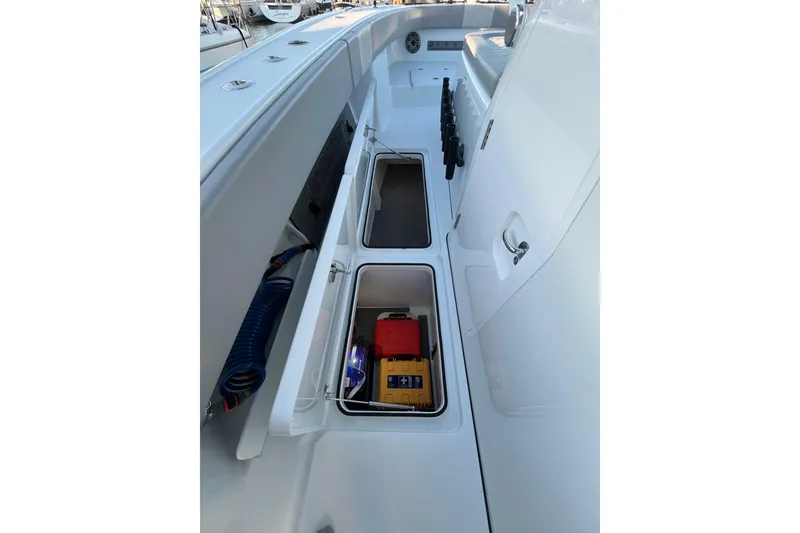 Slide: The Image of Freeman 37VH 2022 boat storage compartments with equipment and coiled hose. - 21