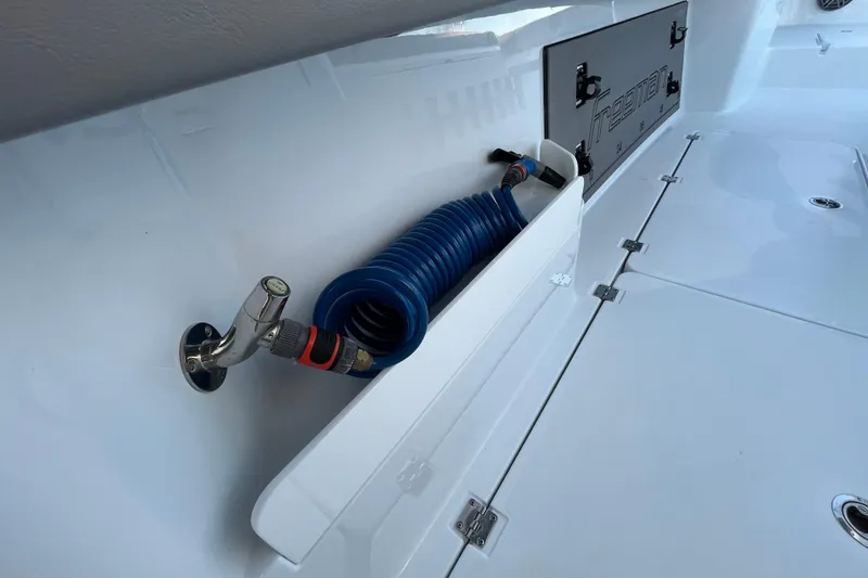 Slide: The Image of Freeman 37VH 2022 boat deck with coiled hose and storage compartment. - 25