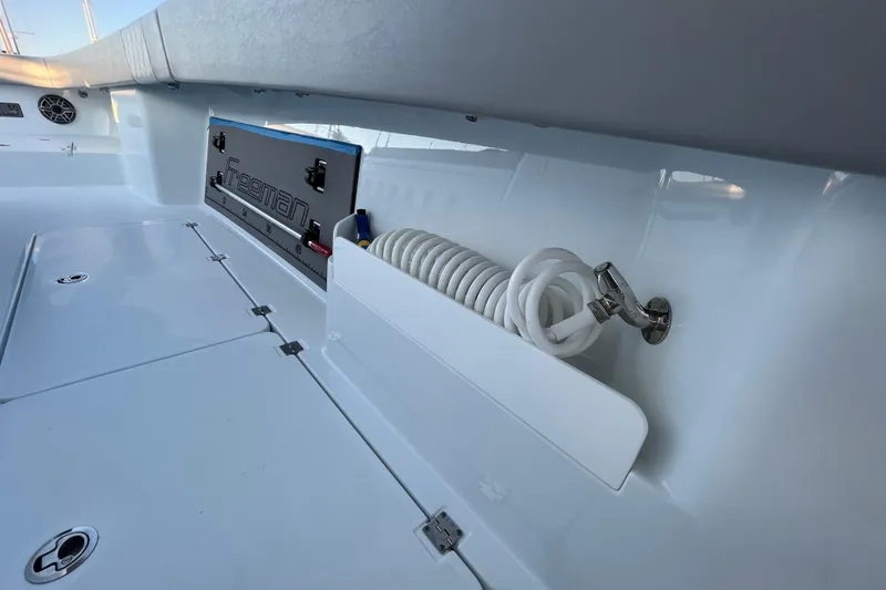 Slide: The Image of Freeman 37VH 2022 boat deck with storage compartment and coiled hose. - 26