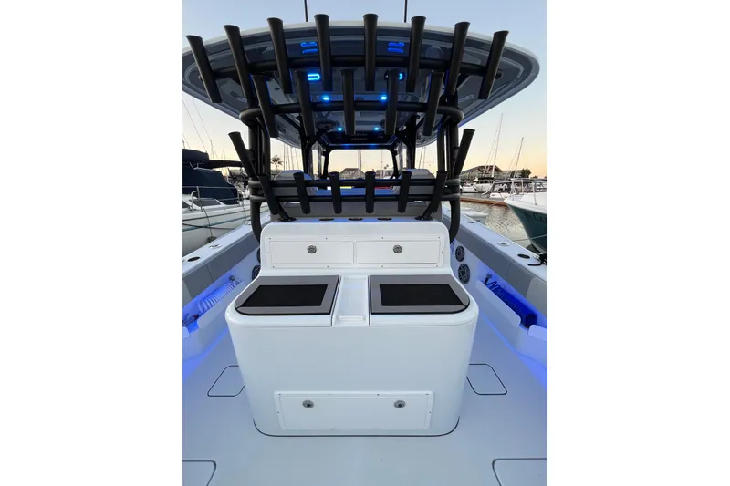 Slide: The Image of 2022 Freeman 37VH boat interior with rod holders and storage compartments at a marina. - 27