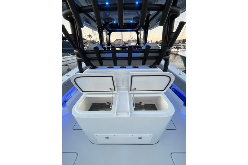 Slide: The Image of Freeman 37VH 2022 boat interior with open storage compartments and rod holders. - 28