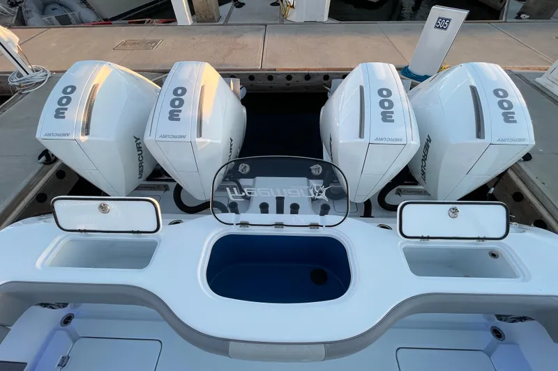 Slide: The Image of Four Mercury 300 outboard engines on a 2022 Freeman 37VH boat at a dock. - 31
