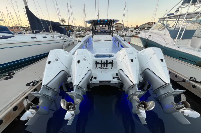 Slide: The Image of 2022 Freeman 37VH boat with four powerful outboard engines docked at a marina. - 33