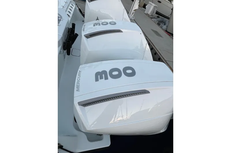 Slide: The Image of Twin Mercury outboard engines on a 2022 Freeman 37VH boat, docked at a marina. - 34