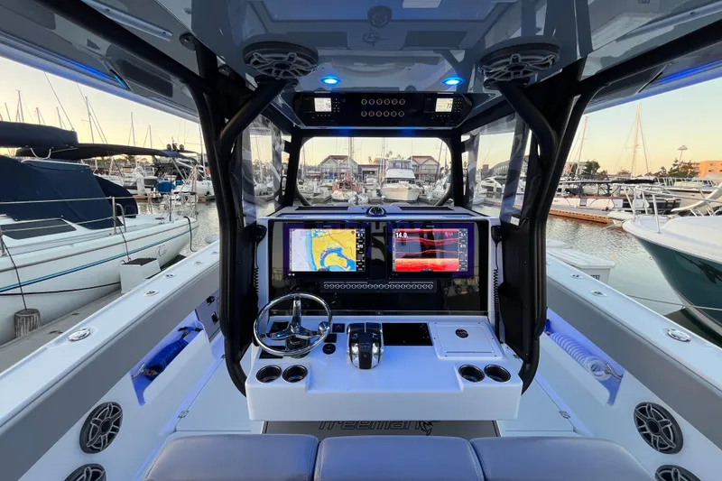 Slide: The Image of Modern Freeman 37VH boat cockpit with advanced navigation systems, docked at a marina, 2022 model. - 5