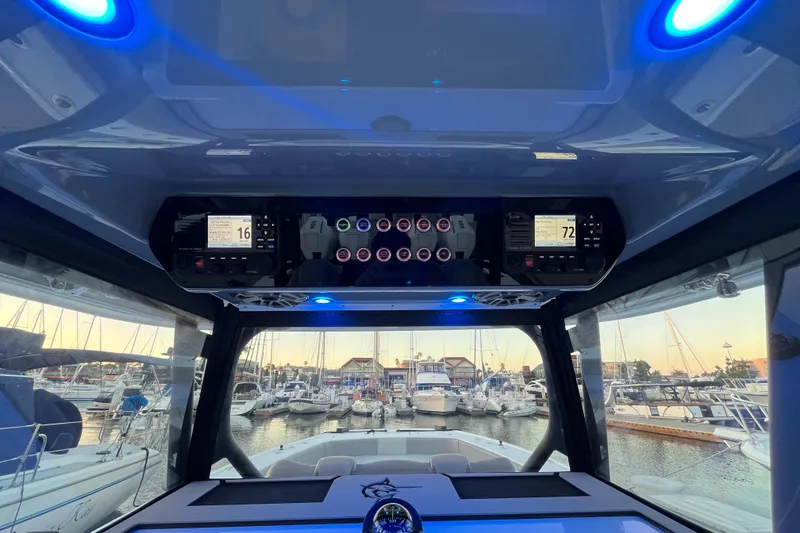 Slide: The Image of Interior view of 2022 Freeman 37VH boat dashboard with blue LED lights at marina. - 7