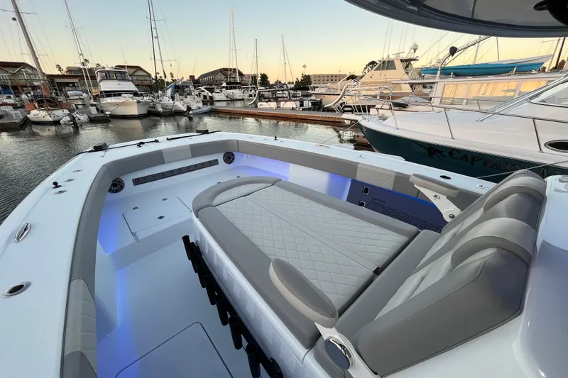 Slide: The Image of Luxurious 2022 Freeman 37VH boat interior at marina, featuring plush seating and ambient lighting. - 9
