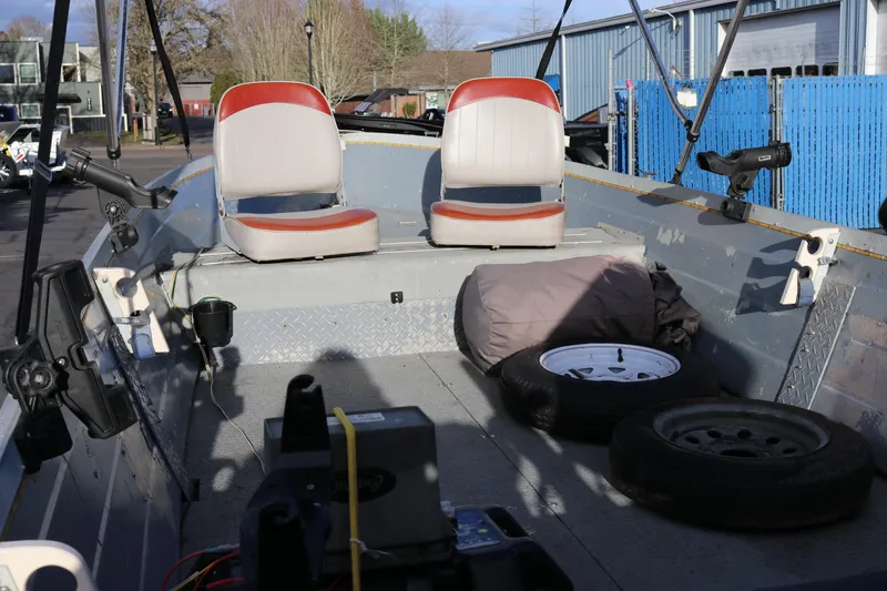 Slide: The Image of 1997 Starcraft Patriot 160 boat interior with seats, spare tires, and equipment. - 10