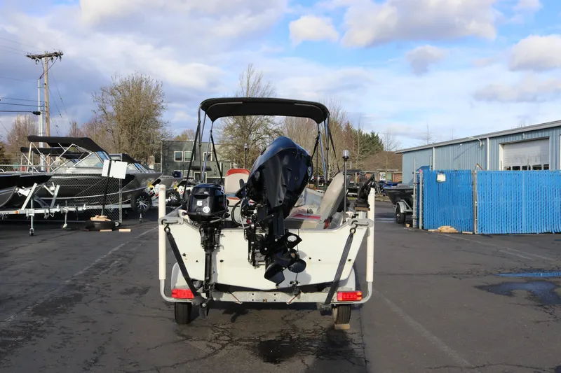 Slide: The Image of 1997 Starcraft Patriot 160 boat with outboard motor in a parking lot. - 5