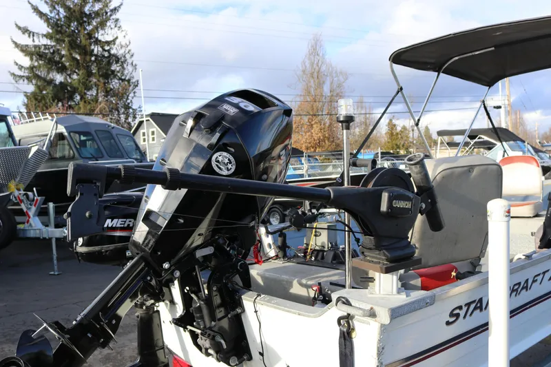 Slide: The Image of 1997 Starcraft Patriot 160 boat with outboard motor and fishing equipment. - 6