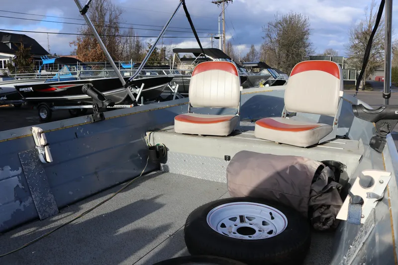 Slide: The Image of 1997 Starcraft Patriot 160 boat interior with two seats and spare tire. - 7