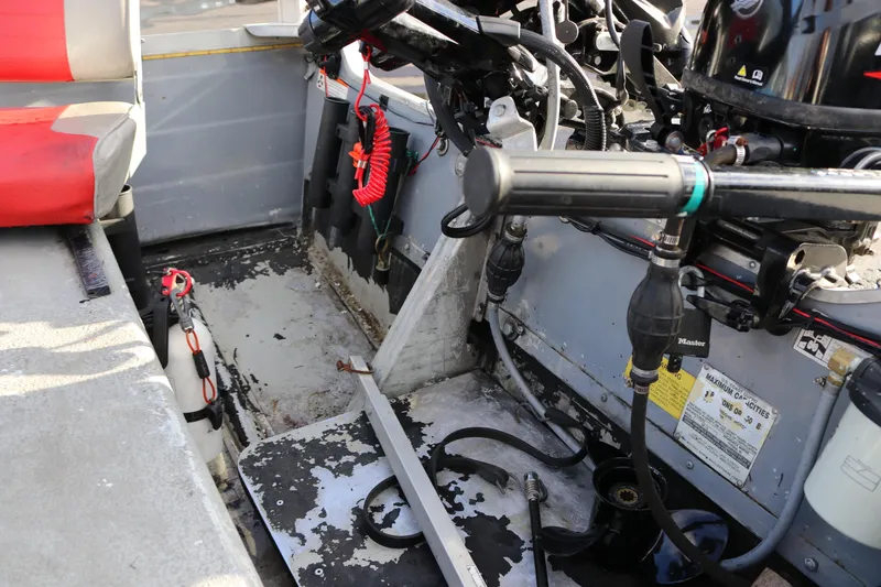 Slide: The Image of Interior of a 1997 Starcraft Patriot 160 boat showing controls and seating. - 11