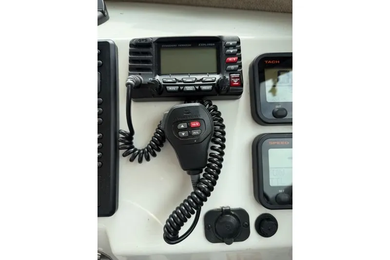 Slide: The Image of Marine radio and controls on a 2015 Parker 2520XLD boat dashboard. - 10