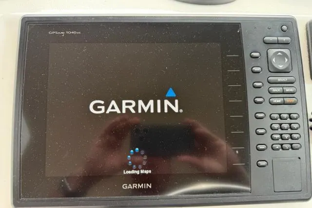 Slide: The Image of Garmin GPSmap 1040xs on 2015 Parker 2520XLD boat, displaying loading maps screen. - 11