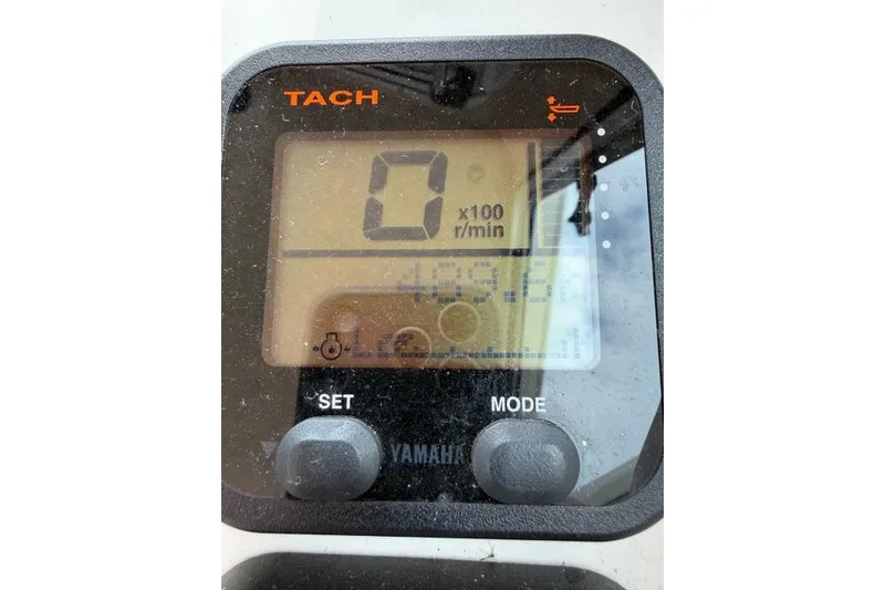 Slide: The Image of Yamaha tachometer display on a 2015 Parker 2520XLD boat, showing zero RPM. - 12