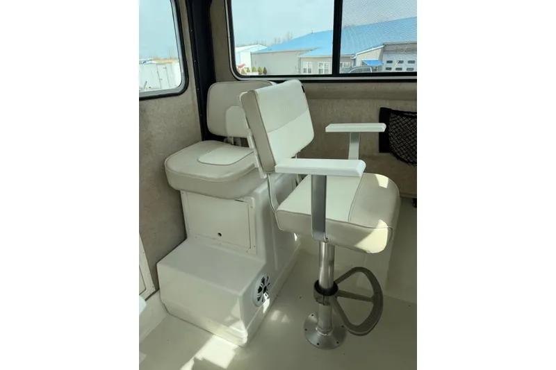 Slide: The Image of Interior seating of a 2015 Parker 2520XLD boat with cushioned chairs and footrest. - 16