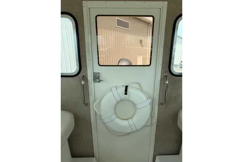 Slide: The Image of Cabin door of 2015 Parker 2520XLD boat with life preserver attached. - 17