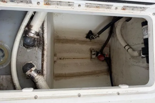 Slide: The Image of Bilge compartment of a 2015 Parker 2520XLD boat, showing hoses and fittings. - 19