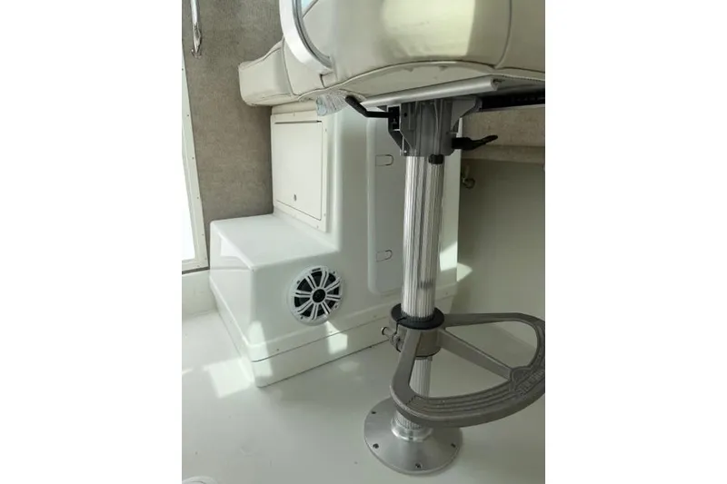 Slide: The Image of Interior of a 2015 Parker 2520XLD boat showing seating and speaker. - 21