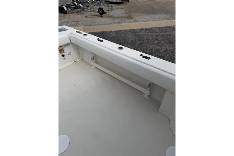 Slide: The Image of 2015 Parker 2520XLD boat interior with rod holders and clean deck. - 24