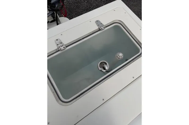 Slide: The Image of Livewell on a 2015 Parker 2520XLD boat, featuring a transparent lid and secure latch. - 25
