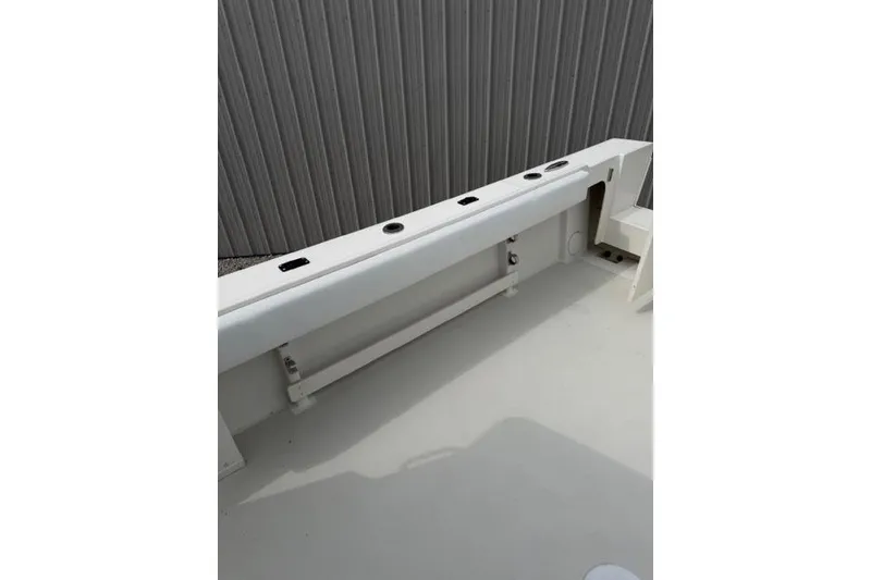 Slide: The Image of 2015 Parker 2520XLD boat deck with rod holders and storage compartments. - 26