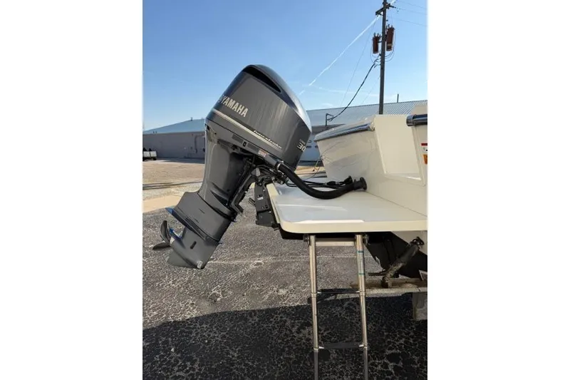 Slide: The Image of 2015 Parker 2520XLD boat with Yamaha outboard motor, parked outdoors. - 30
