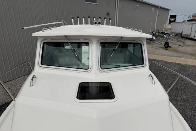 Slide: The Image of 2015 Parker 2520XLD boat front view with dual windows and rooftop rods. - 4
