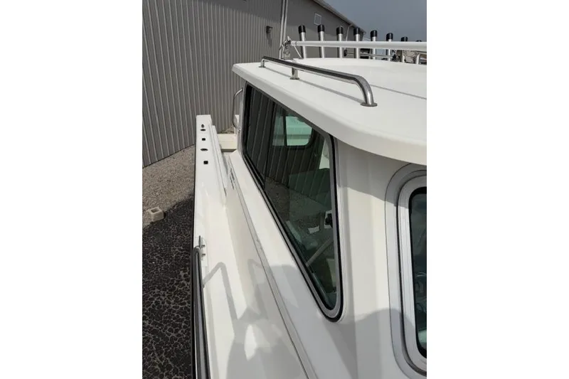 Slide: The Image of 2015 Parker 2520XLD boat side view with cabin and railing details. - 6