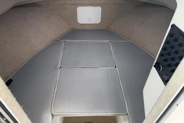 Slide: The Image of Interior cabin of a 2015 Parker 2520XLD boat with cushioned seating. - 8