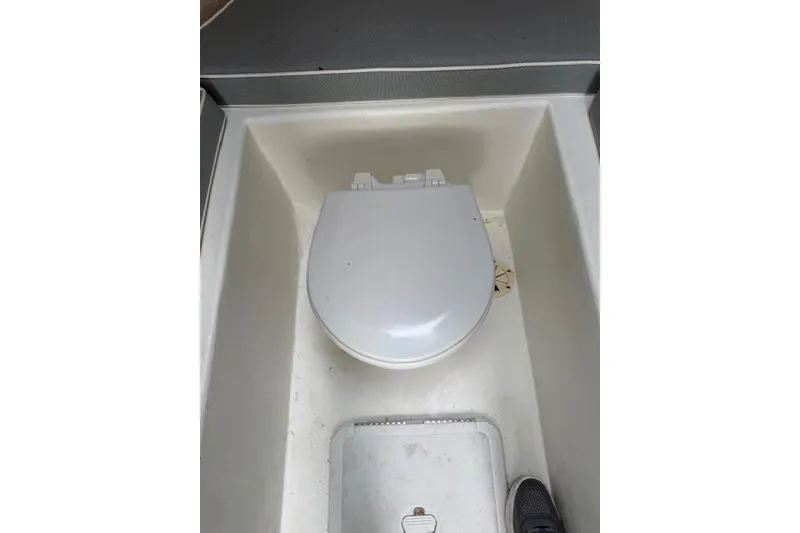 Slide: The Image of Boat toilet in a 2015 Parker 2520XLD, featuring a compact design. - 9