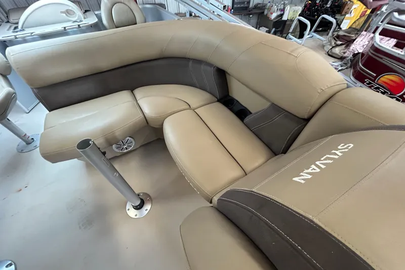 Slide: The Image of 2021 Sylvan Mirage Fish 820 CNF boat interior with beige seating and speaker. - 7